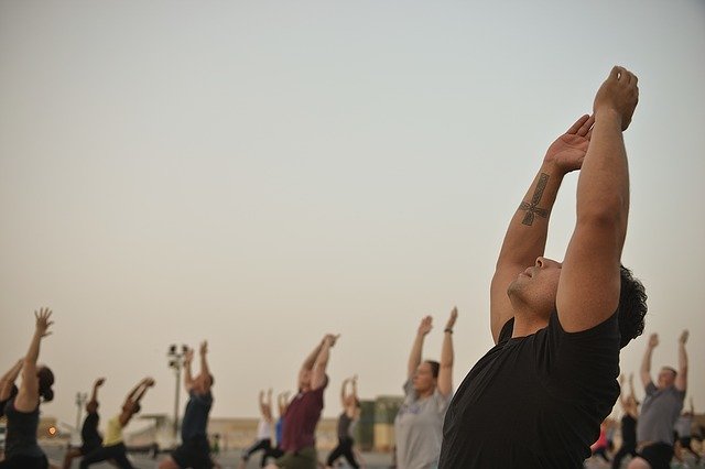 Group of me performing Yoga Outdoors