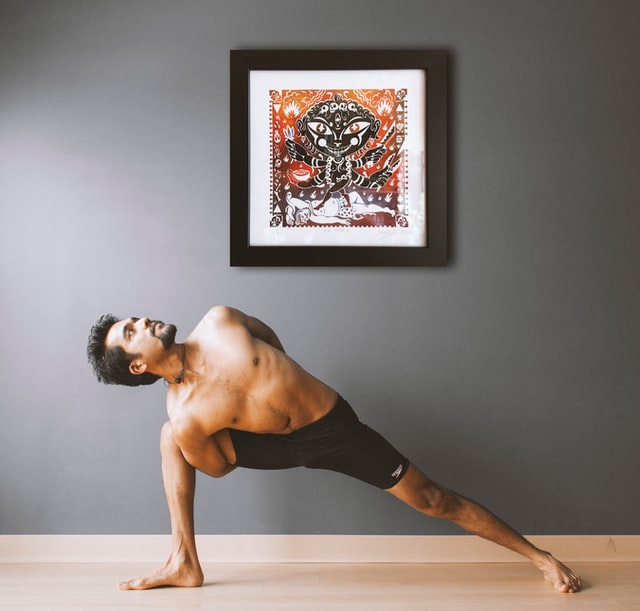 Man performing yoga in a room